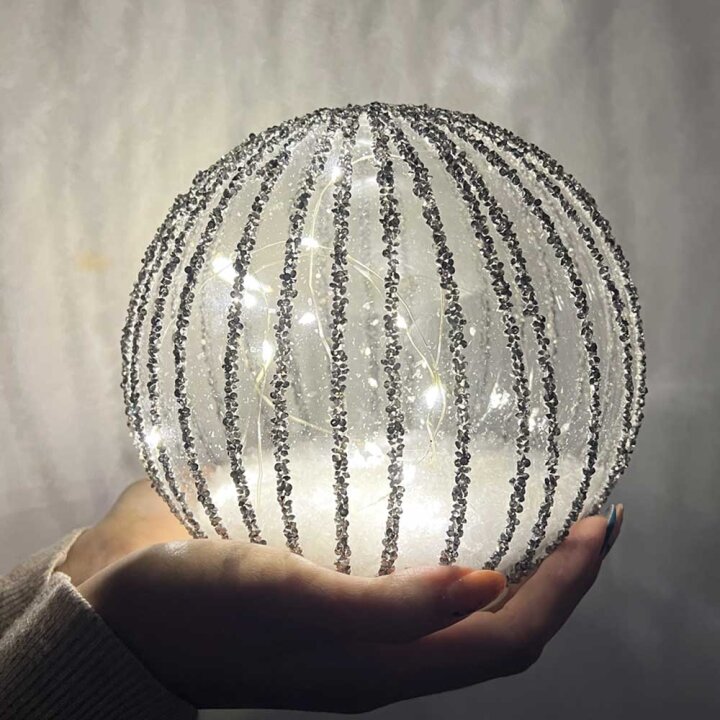 KUGLA S LED SVJETLIMA NA BATERIJE - SREBRNE GLITER LINIJE 15 cm